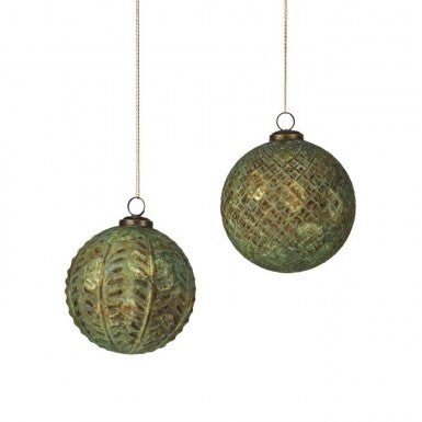 Two 5-inch antique green and gold check pattern glass ball ornaments hanging by strings.