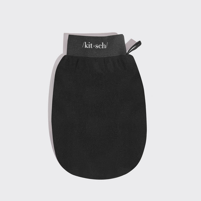 Black exfoliating glove with textured silicone nubs on the palm.