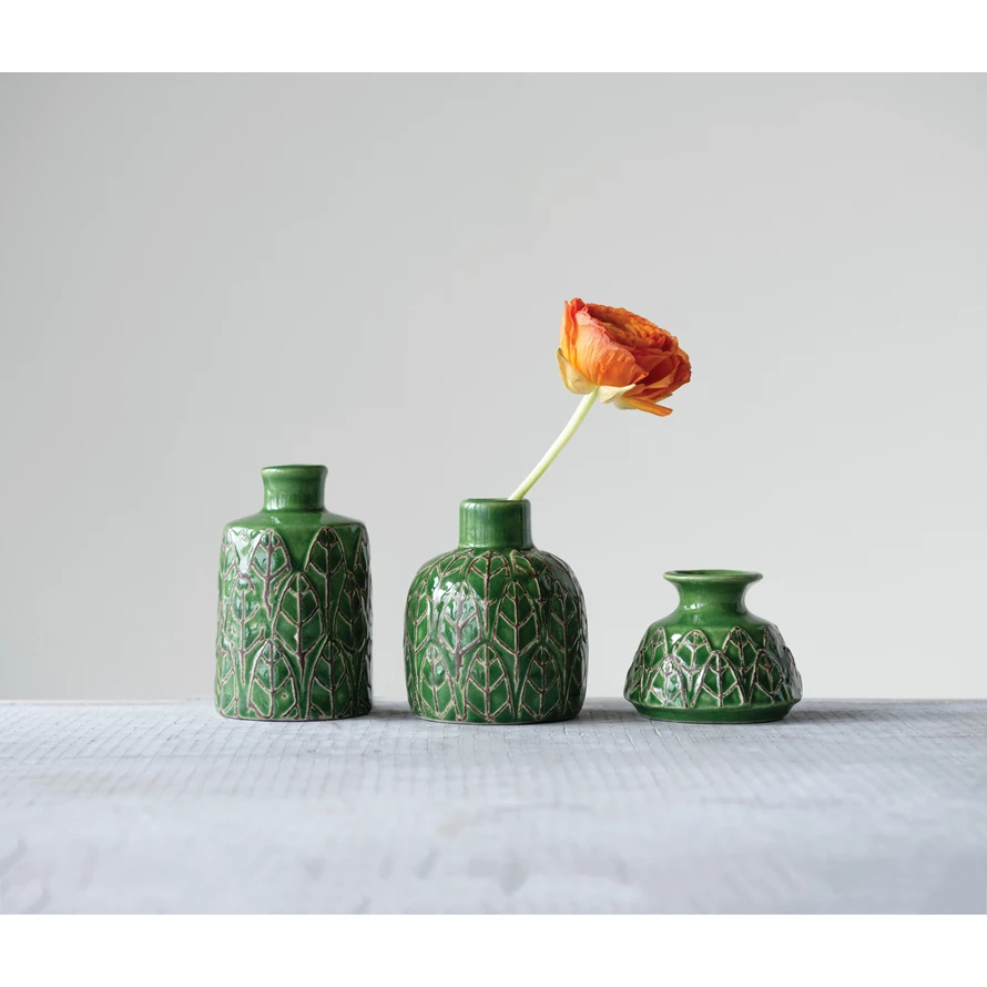 Two embossed stoneware vases in neutral tones with textured geometric patterns.