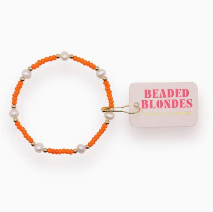 Elastic pearl bracelet with synthetic pearls on a gold-filled cord.