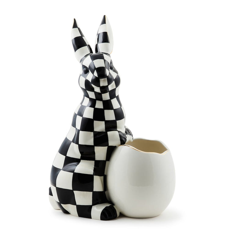 Large ceramic bunny vase with black and white checkered pattern holding a white egg-shaped vessel.