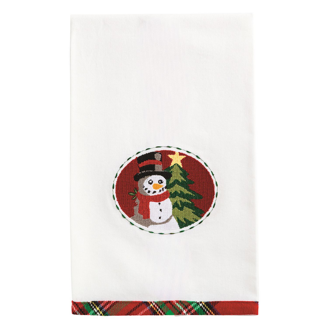 White cotton hand towel with a needlepoint snowman and tree design and a red tartan hem.