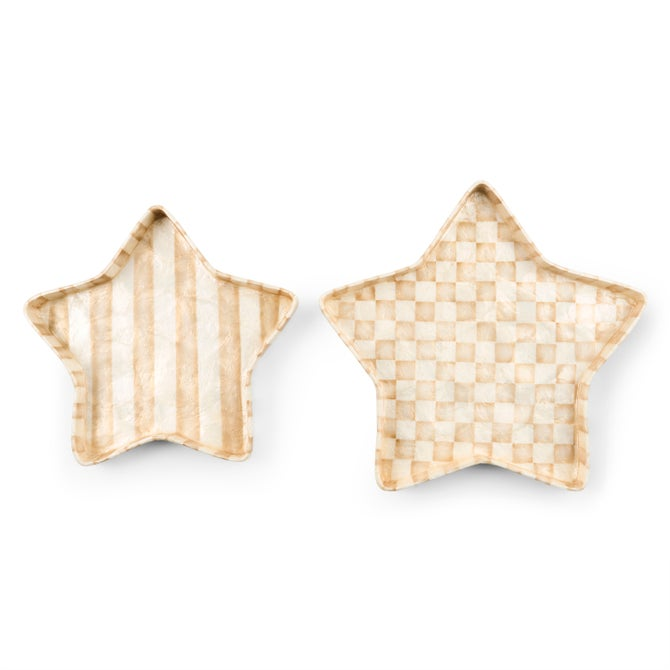 Two star-shaped capiz trays in mocha and white, one with stripes and one with a checkered pattern.