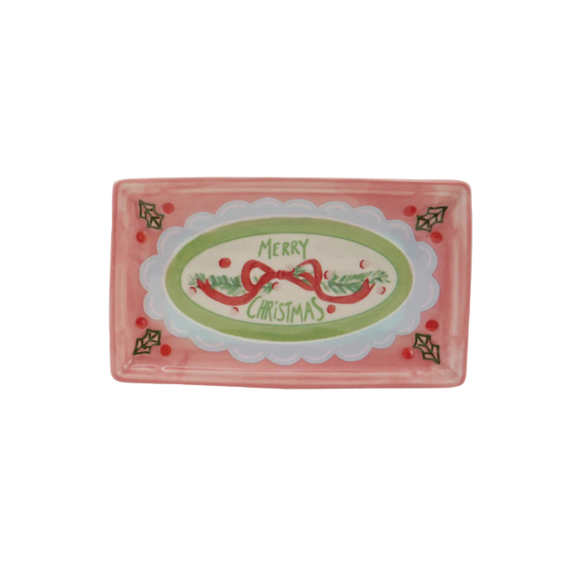 Pink rectangular stoneware dish featuring a 'Merry Christmas' design with a red bow and holly.