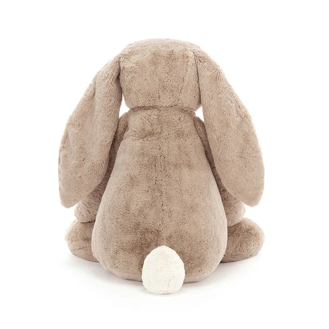 Back view of a Bashful Beige Bunny Gigantic plush toy with long floppy ears and a white fluffy tail.