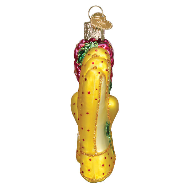 Side view of a yellow glass gardening glove ornament with red polka dots and glitter accents.