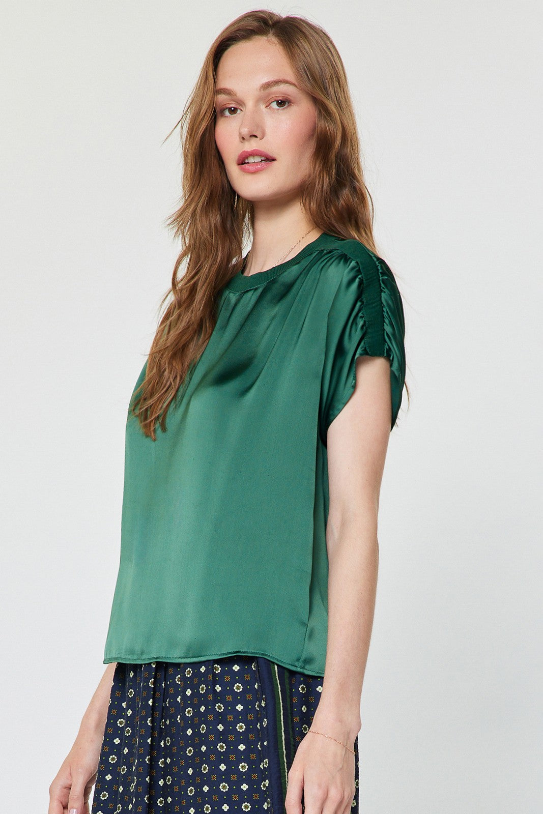 Mina round neck short sleeve cropped blouse in polyester satin with gathered shoulders.