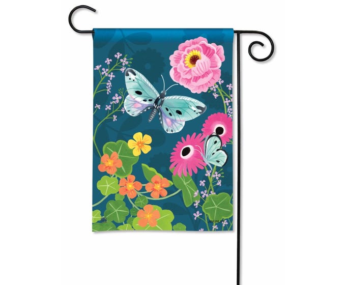 Green garden flag with white floral vine pattern on a pole.