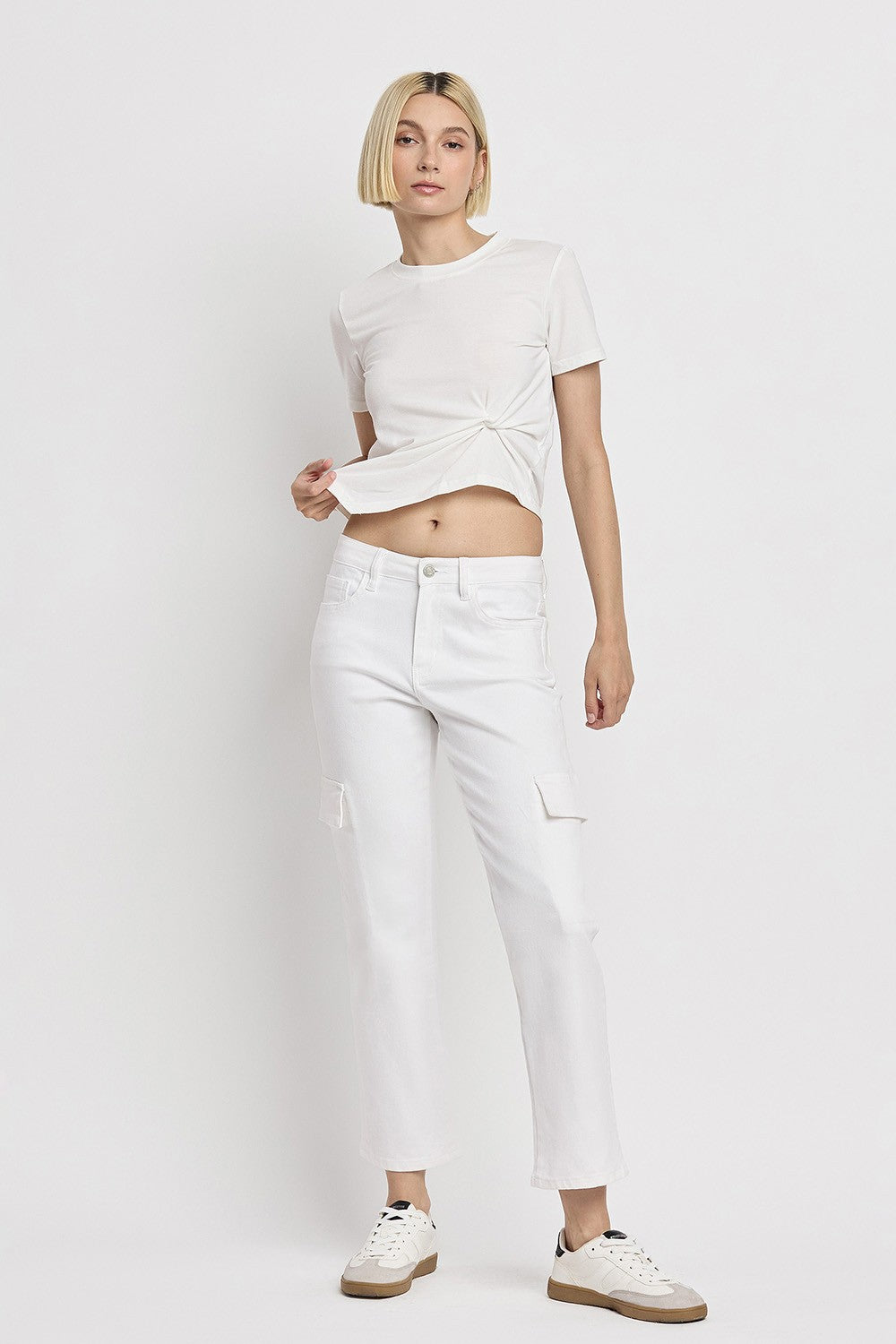Woman wearing Megan white high-rise cropped straight-leg cargo jeans with a white t-shirt.