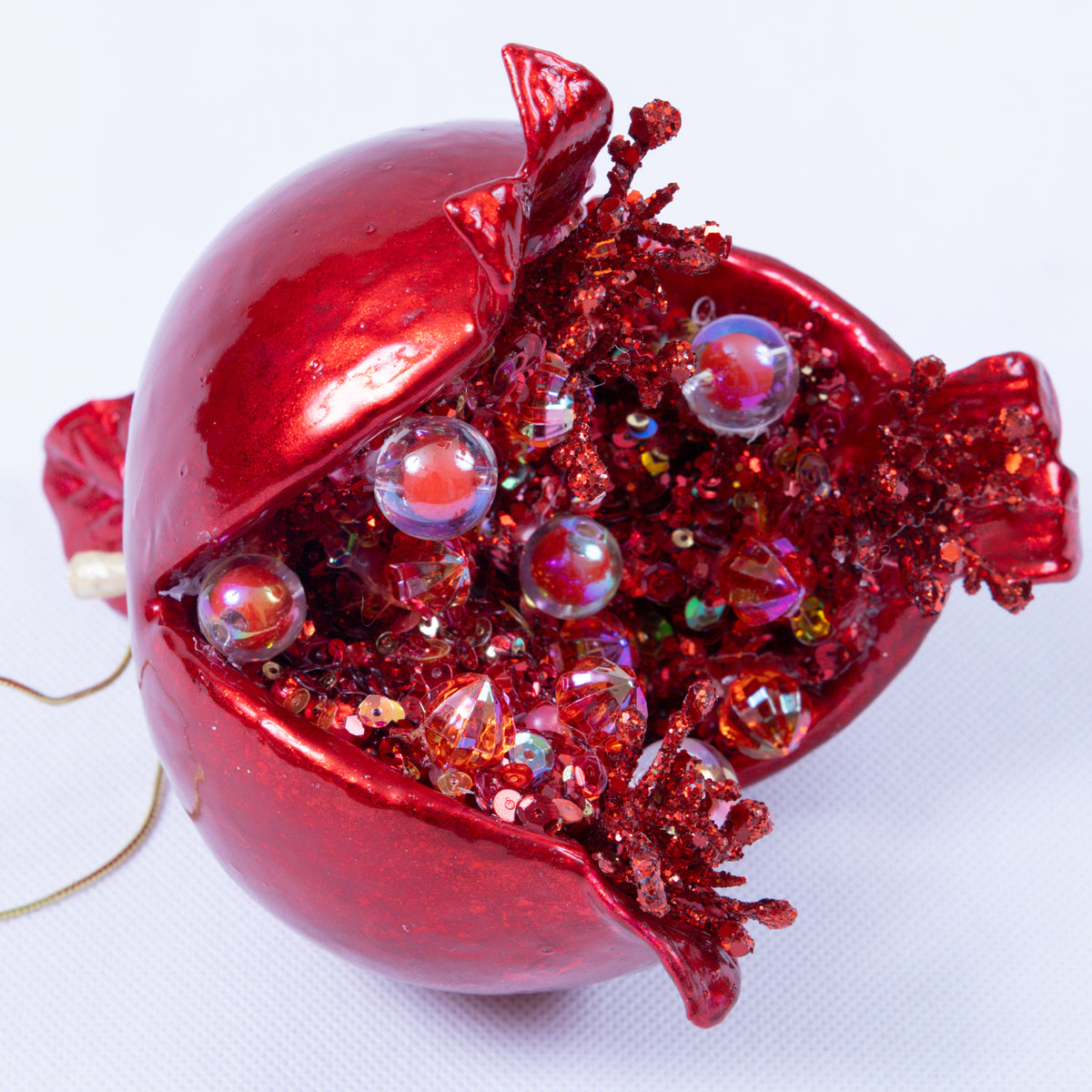5-inch red candy apple pomegranate ornament with glitter and jewel-like seeds inside.