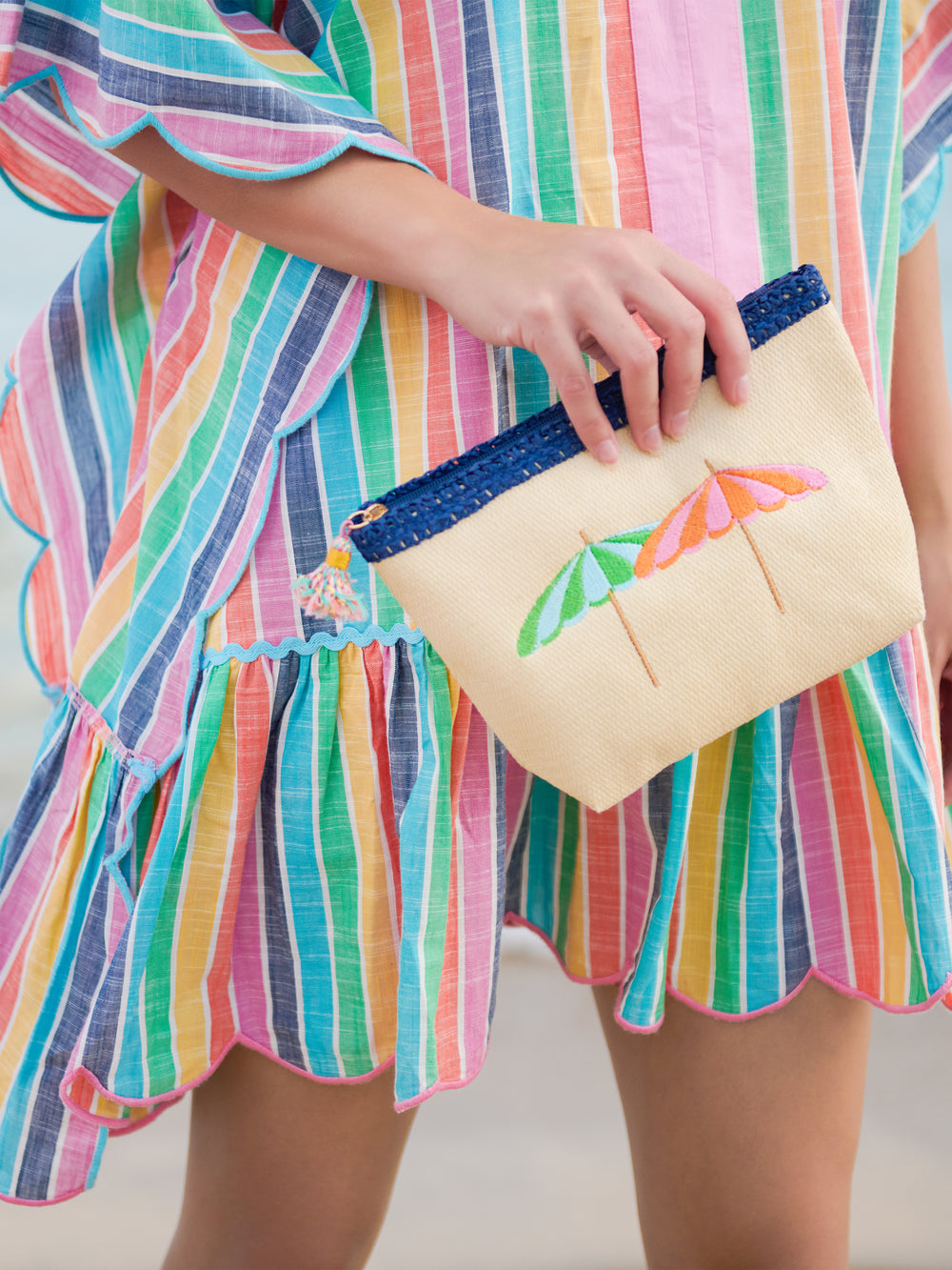 Capri Zip Pouch in natural paper straw with a coordinating tassel zipper pull.