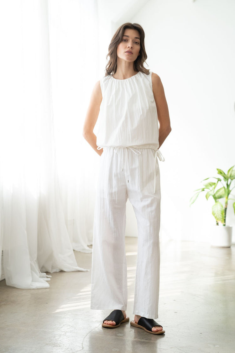 Front view of Laura elastic waist wide-leg linen pants in natural crinkled fabric with side pockets.