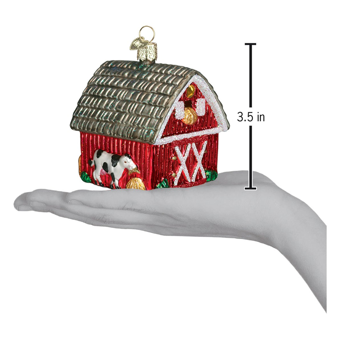 Glass barn Christmas ornament with a cow and 3.5 inch height indicator held in a hand.