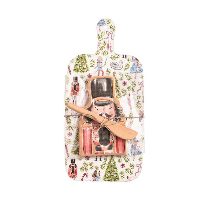 Christmas melamine paddle board set with nutcracker napkins and a wooden spreader.