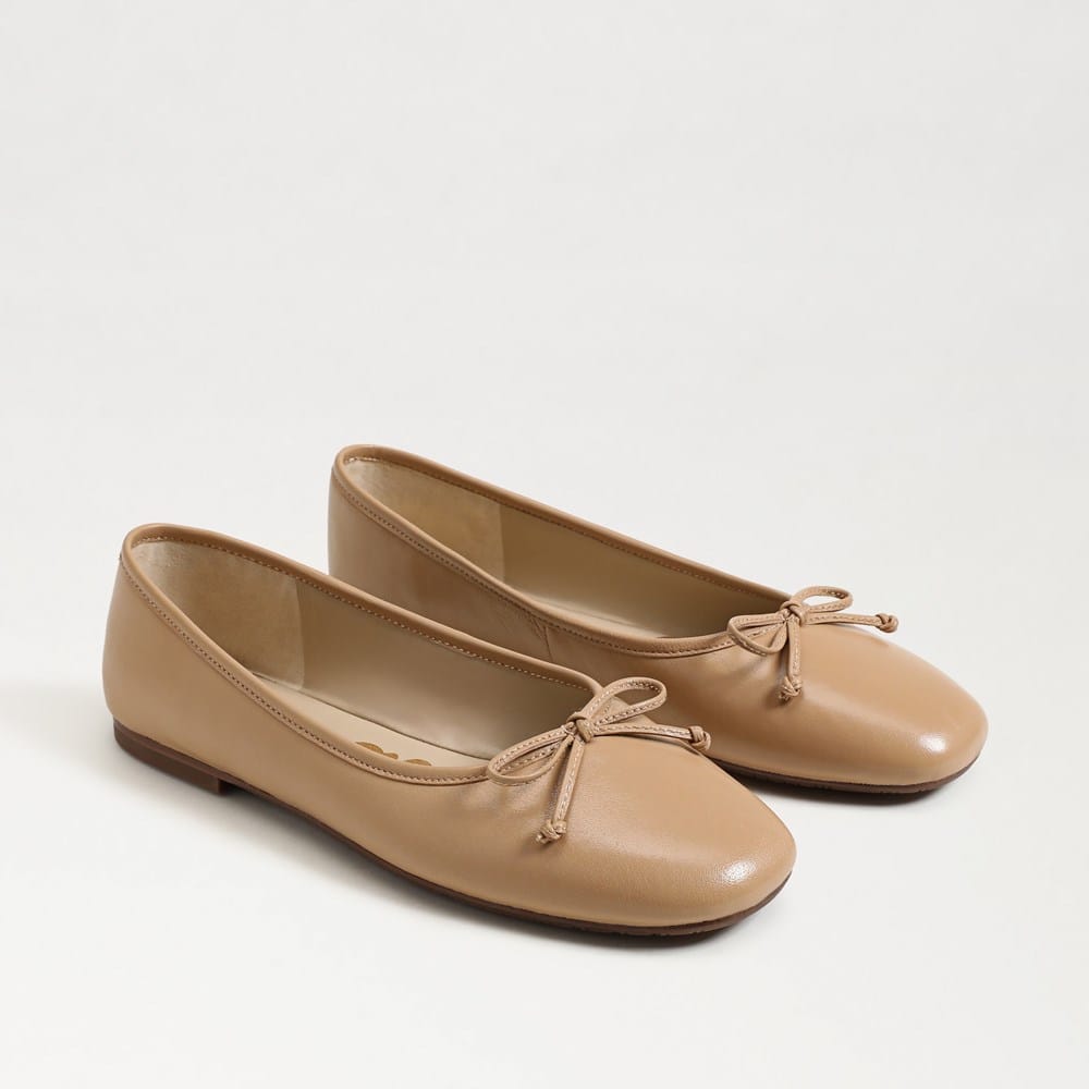 A pair of tan leather Alie Ballet Flats with round toes and decorative bow details.
