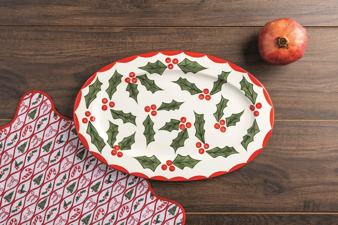 Oval white ceramic Holly Platter with a red scalloped rim and green holly leaf and berry pattern.