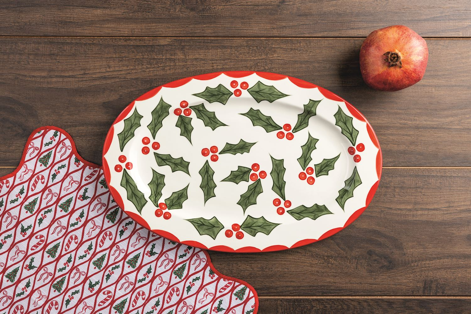 Oval white ceramic Holly Platter with a red scalloped rim and green holly leaf and berry pattern.