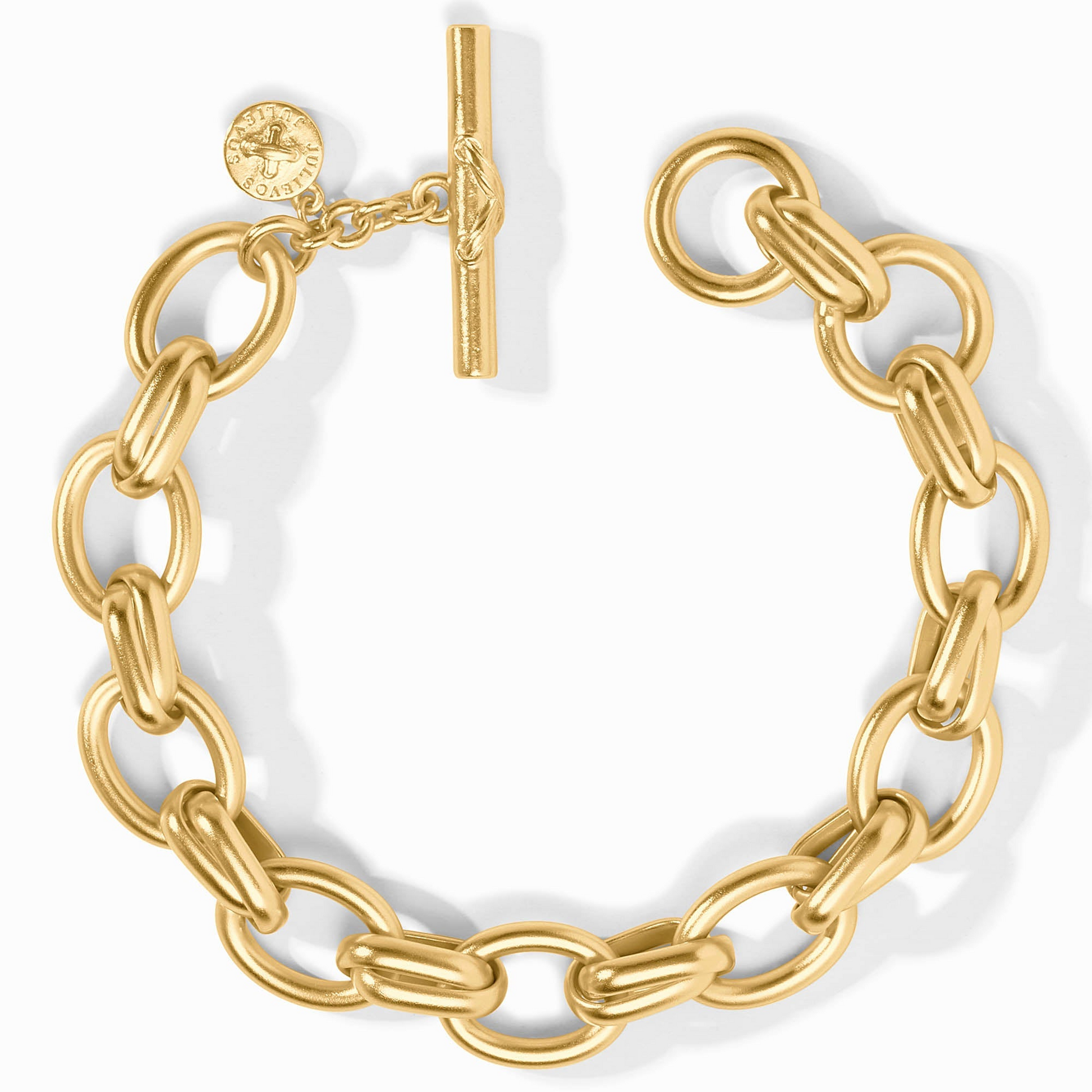 Gold Essex Link Bracelet with a toggle clasp and a small circular logo charm.