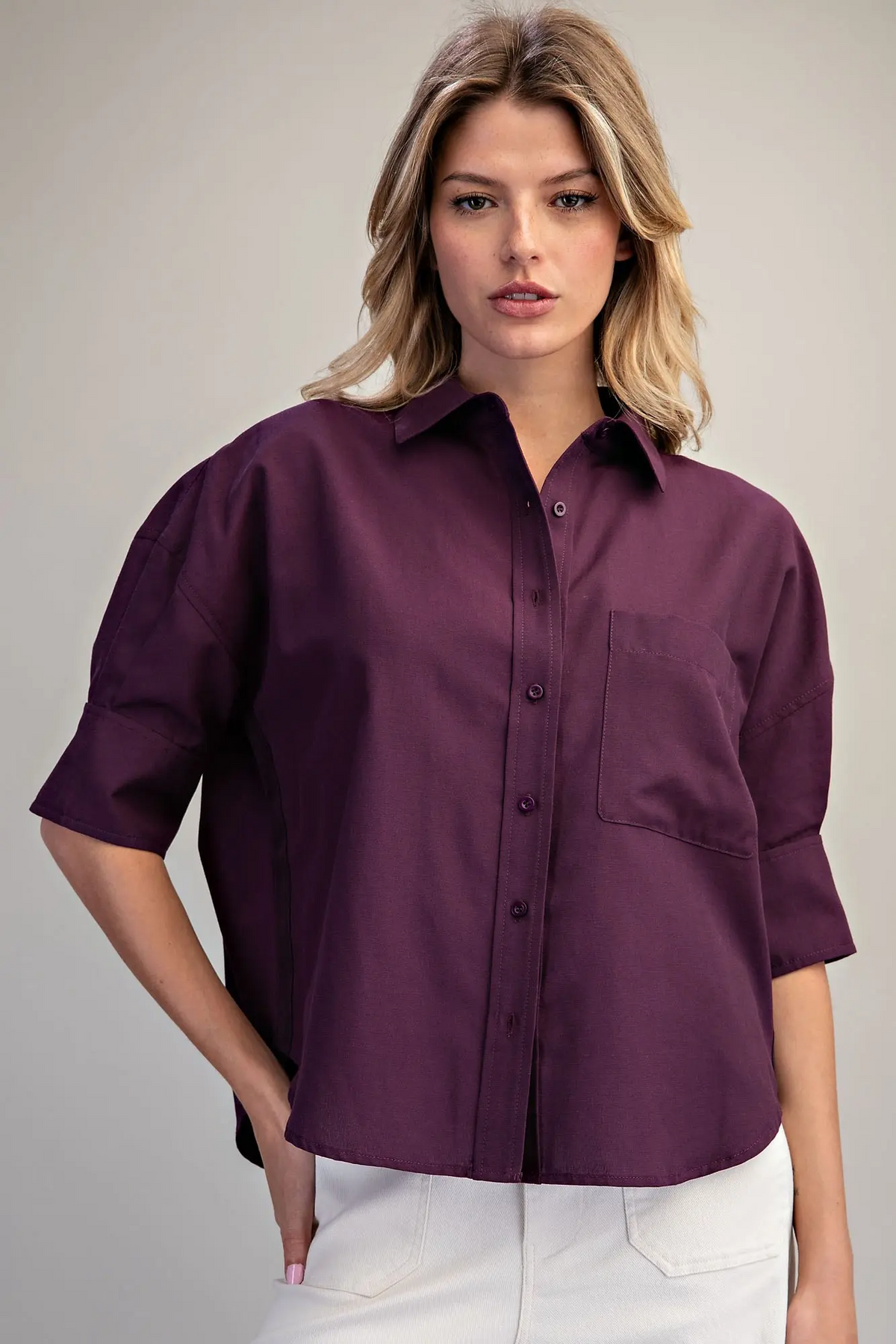 Woman wearing the Lou TH17477, a plum-colored oversized button-up shirt with elbow-length sleeves.