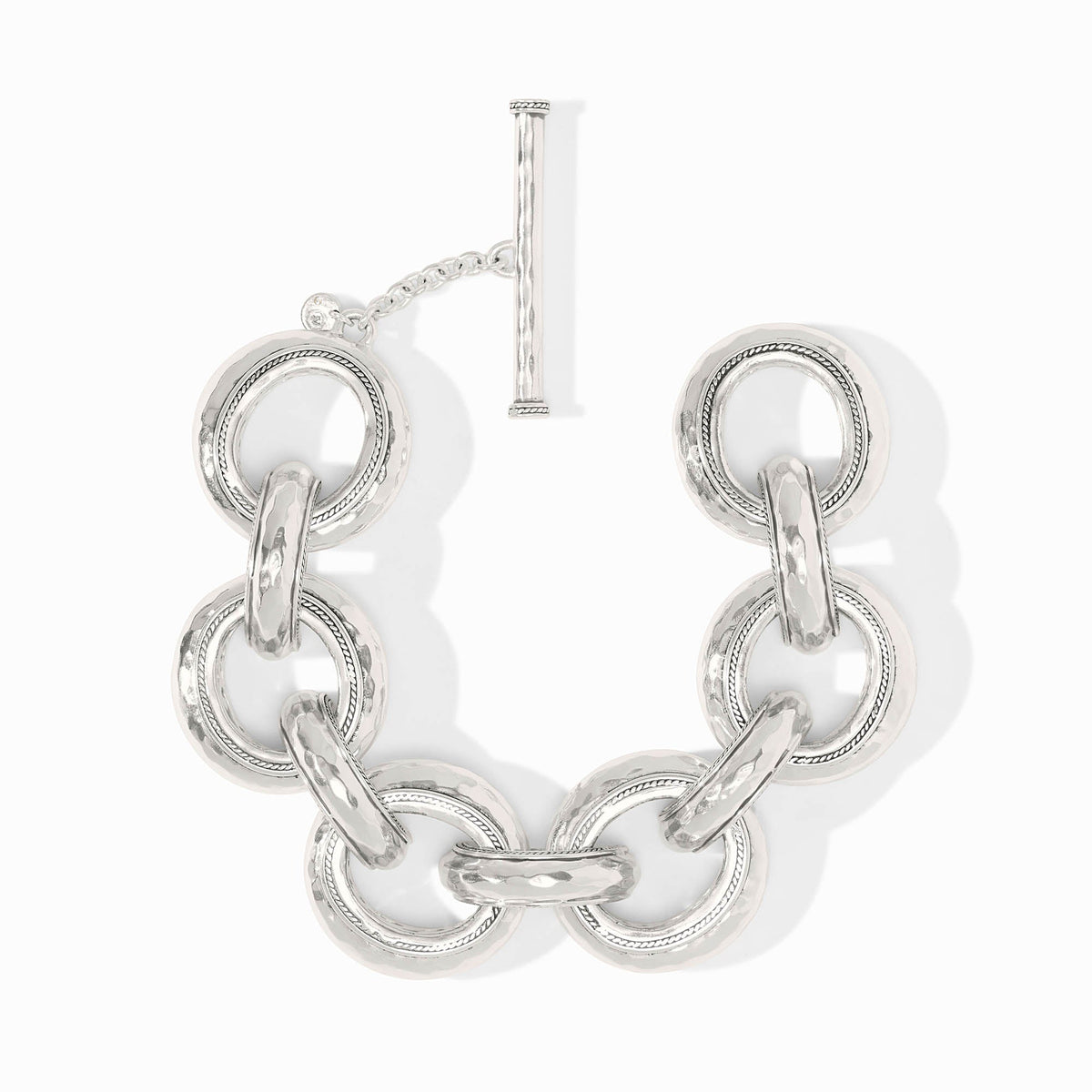 Silver Cannes Link Bracelet with hammered texture, pierced inner design, and a toggle closure.