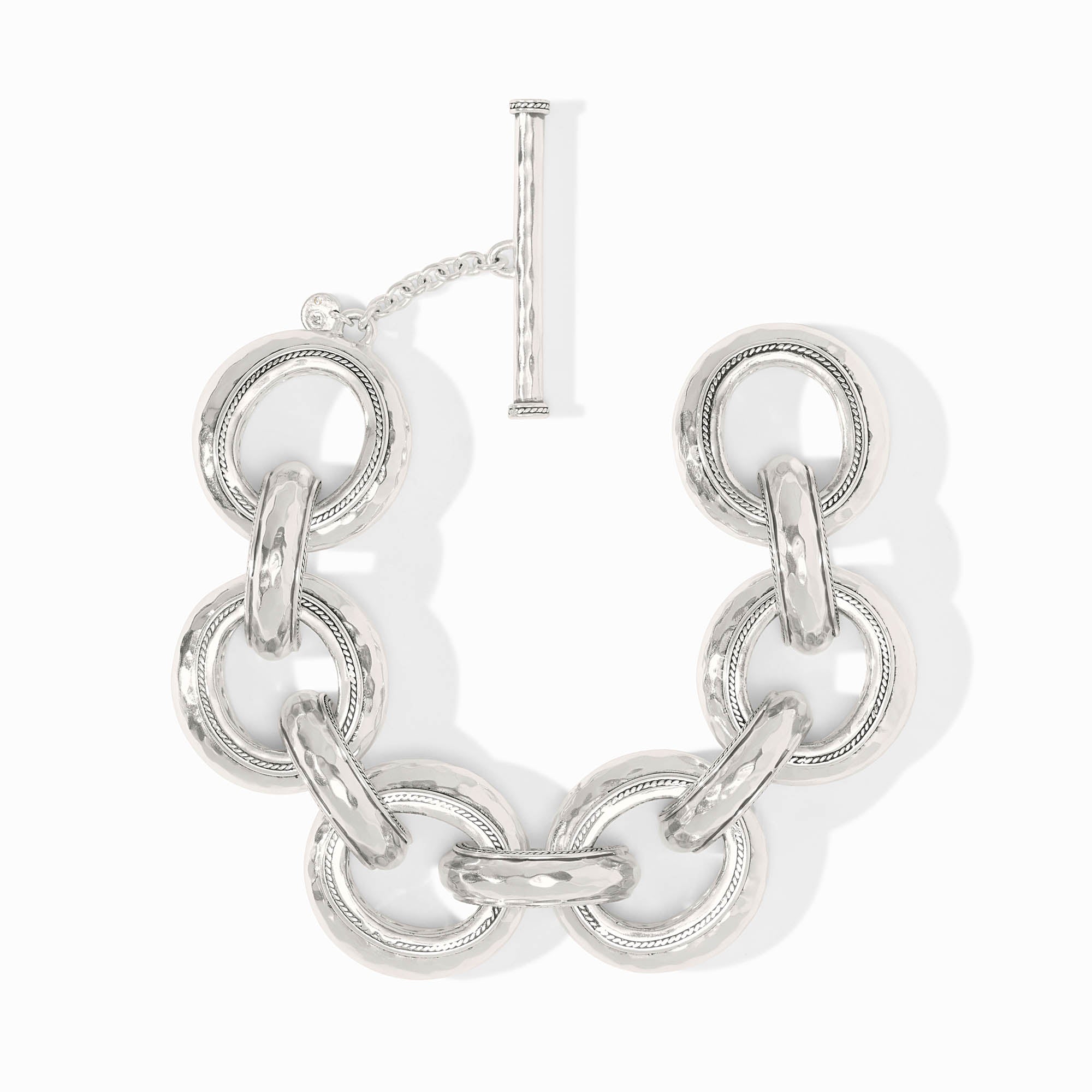 Silver Cannes Link Bracelet with hammered texture, pierced inner design, and a toggle closure.