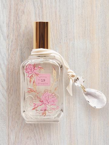 Lolita Lempicka BREATHE Eau de Parfum bottle with pink floral design and crystal charm.