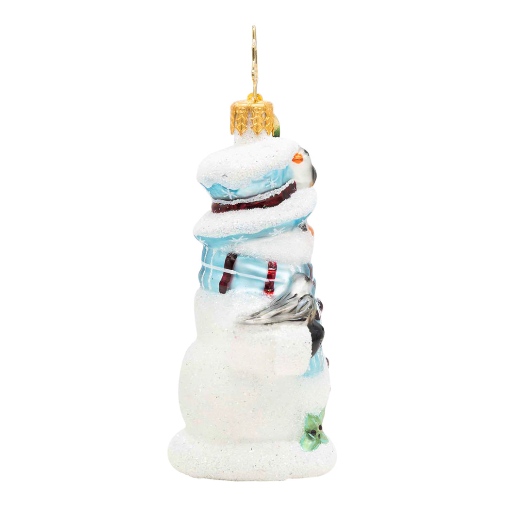 Snowy Perch Pals Gem glass ornament featuring a glittery snowman with blue and red accents.