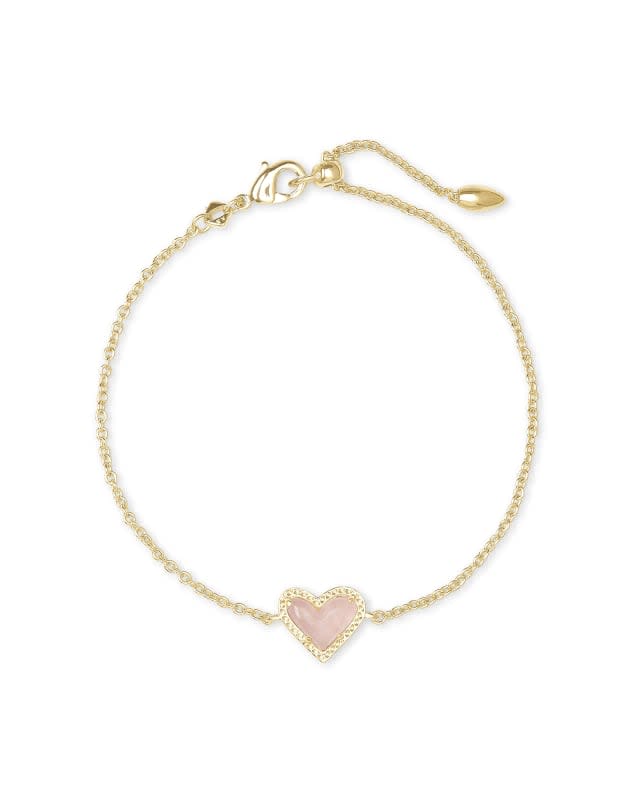 Ari Heart Gold Chain Bracelet featuring a rose quartz heart pendant on an adjustable yellow gold over brass chain.