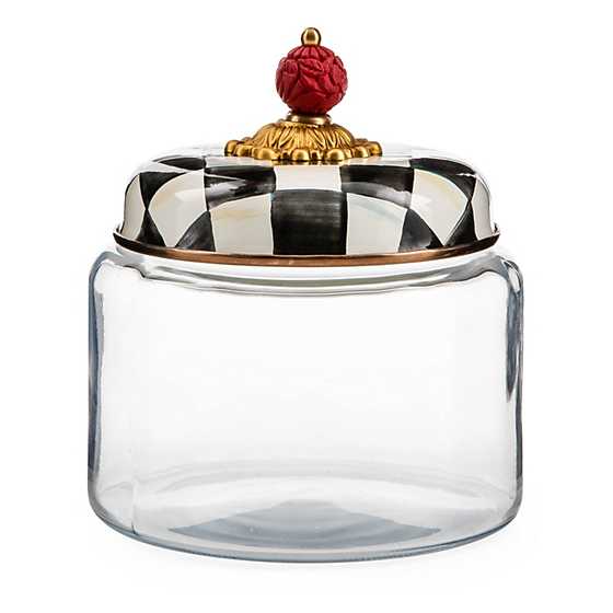 Small glass kitchen canister with a black and white checkered lid and a red cinnabar knob.