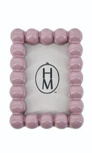 Small rectangular pink resin photo frame magnet with a decorative bubble-textured border.
