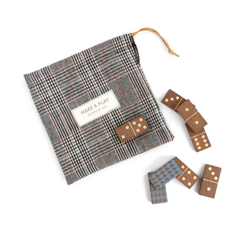 Brown domino set with a plaid drawstring bag. Some dominoes have dots, others have a blue houndstooth pattern.