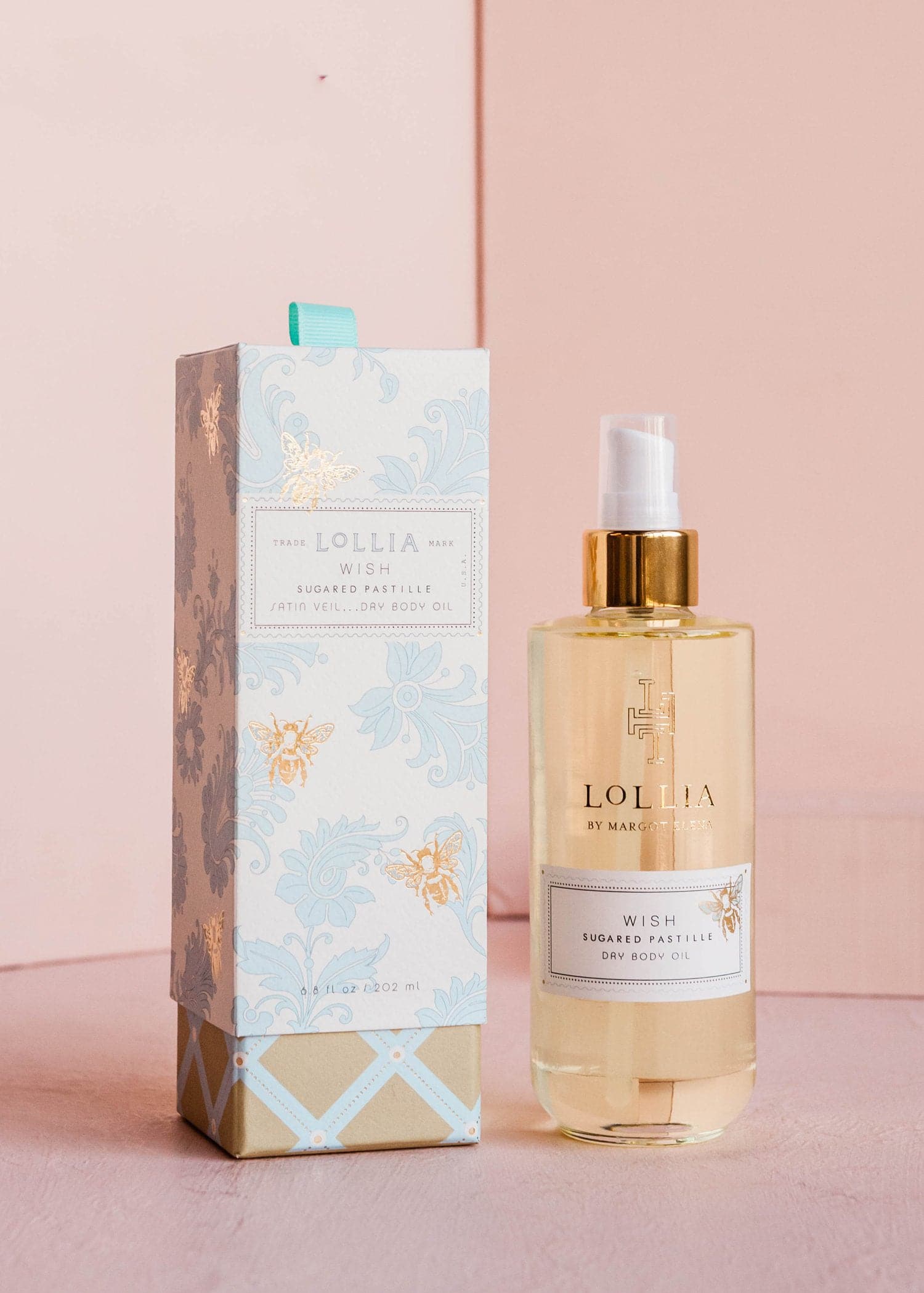 Bottle of Wish Dry Body Oil with pomegranate green tea scent in clear glass