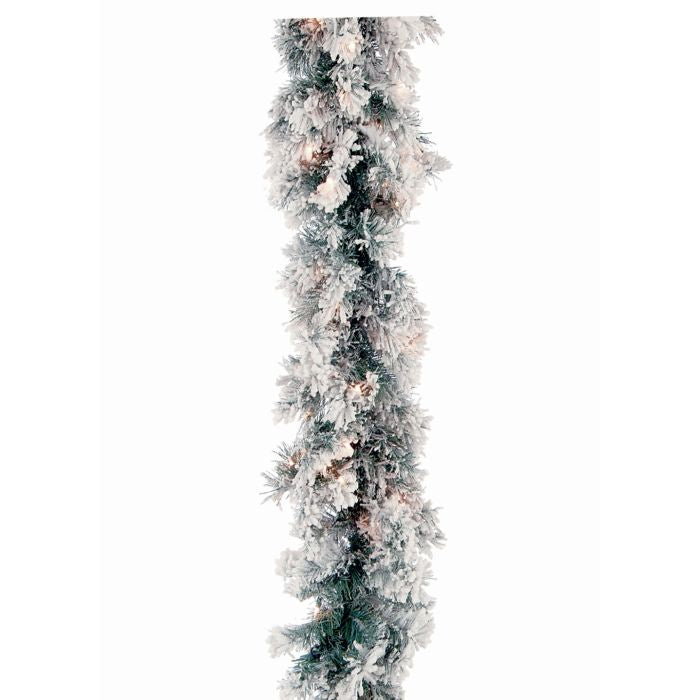A 9-foot pre-lit flocked pine garland with white snow-covered needles and warm white lights.