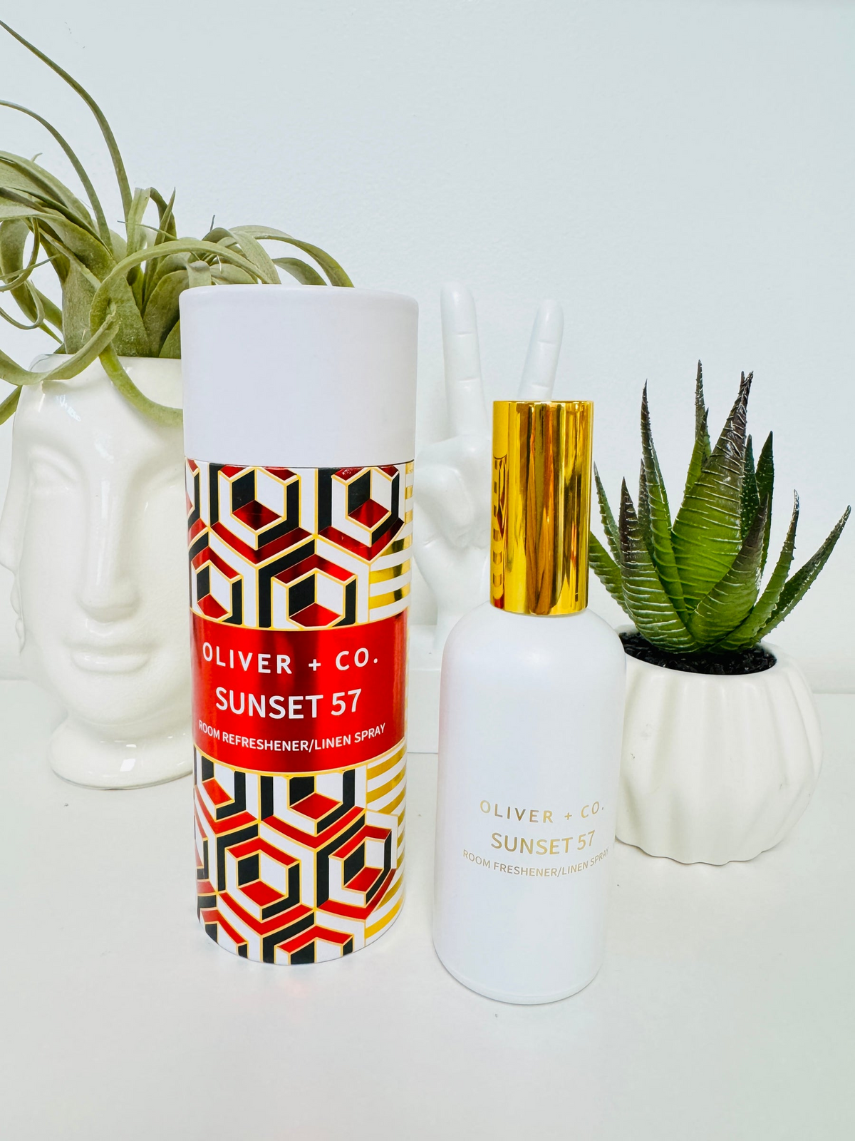 Oliver + Co. Sunset 57 Room Refresher and Linen Spray bottle with its decorative geometric tube.