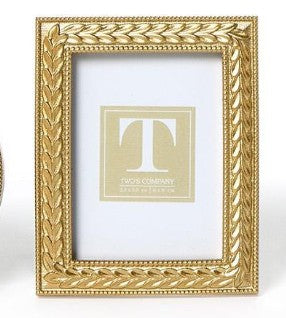 Rectangular gold photo frame with an intricate laurel wreath design and beaded inner border.