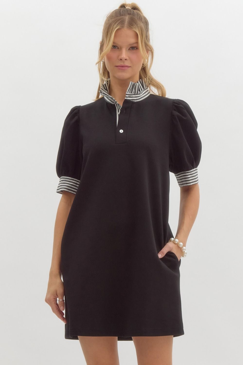 Solid navy knit polo dress with short sleeves, ruffled neckband, side pockets, and a relaxed silhouette.
