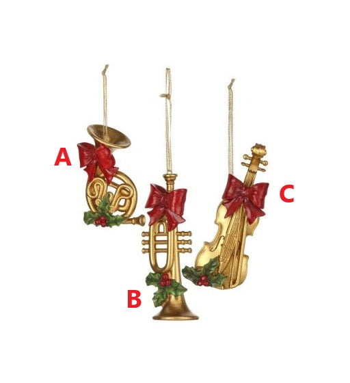 Gold resin musical instrument ornaments with red bows and holly: French horn, trumpet, and violin.