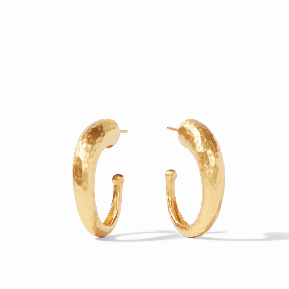 A pair of 24K gold plated hammered hoop earrings with a textured finish and post back closure.