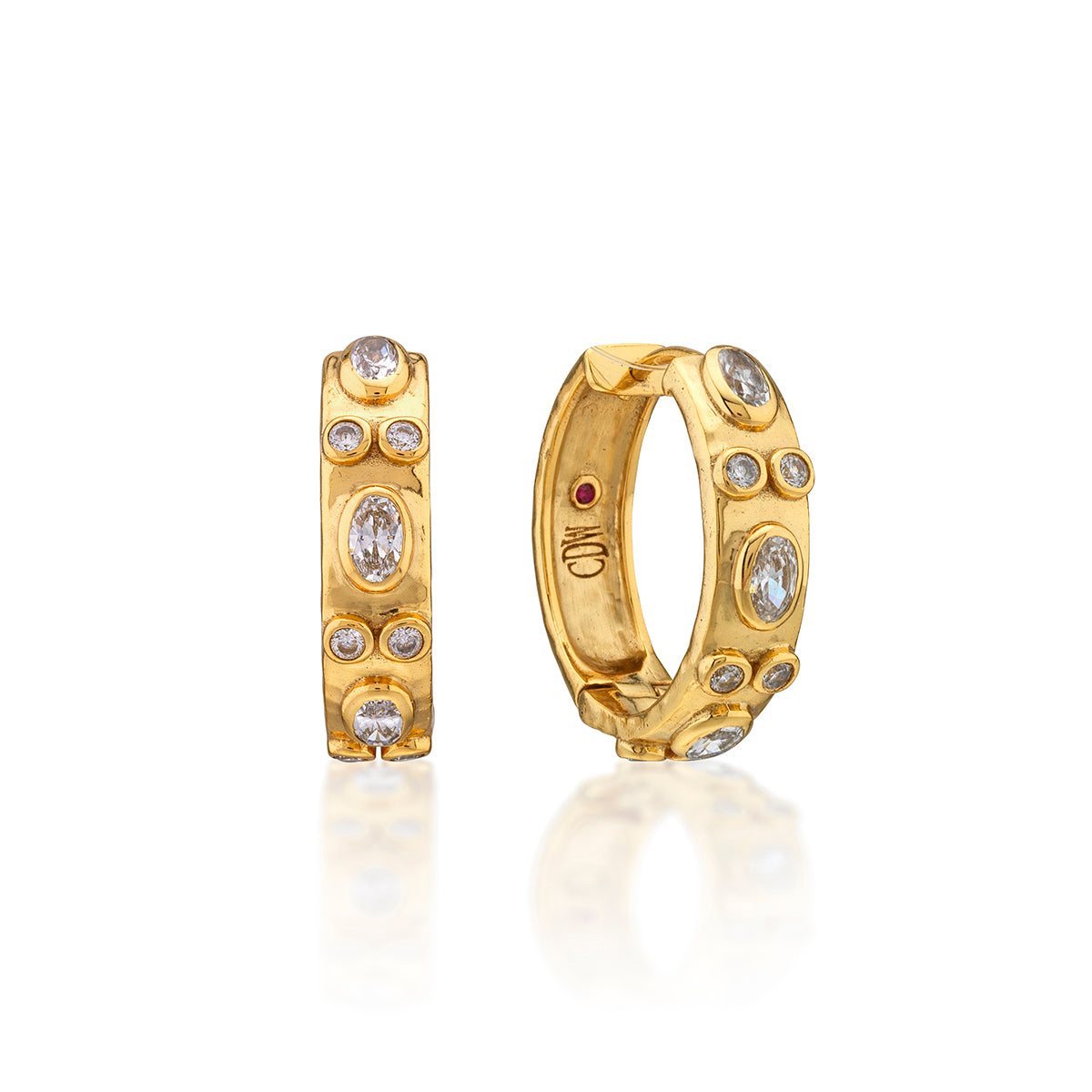 Maharani Huggie Hoop Earrings in gold with bezel-set oval and round clear cubic zirconia stones.
