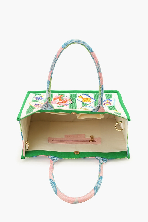 Interior view of a green and white mahjong-themed beaded tote with pockets and a magnetic closure.
