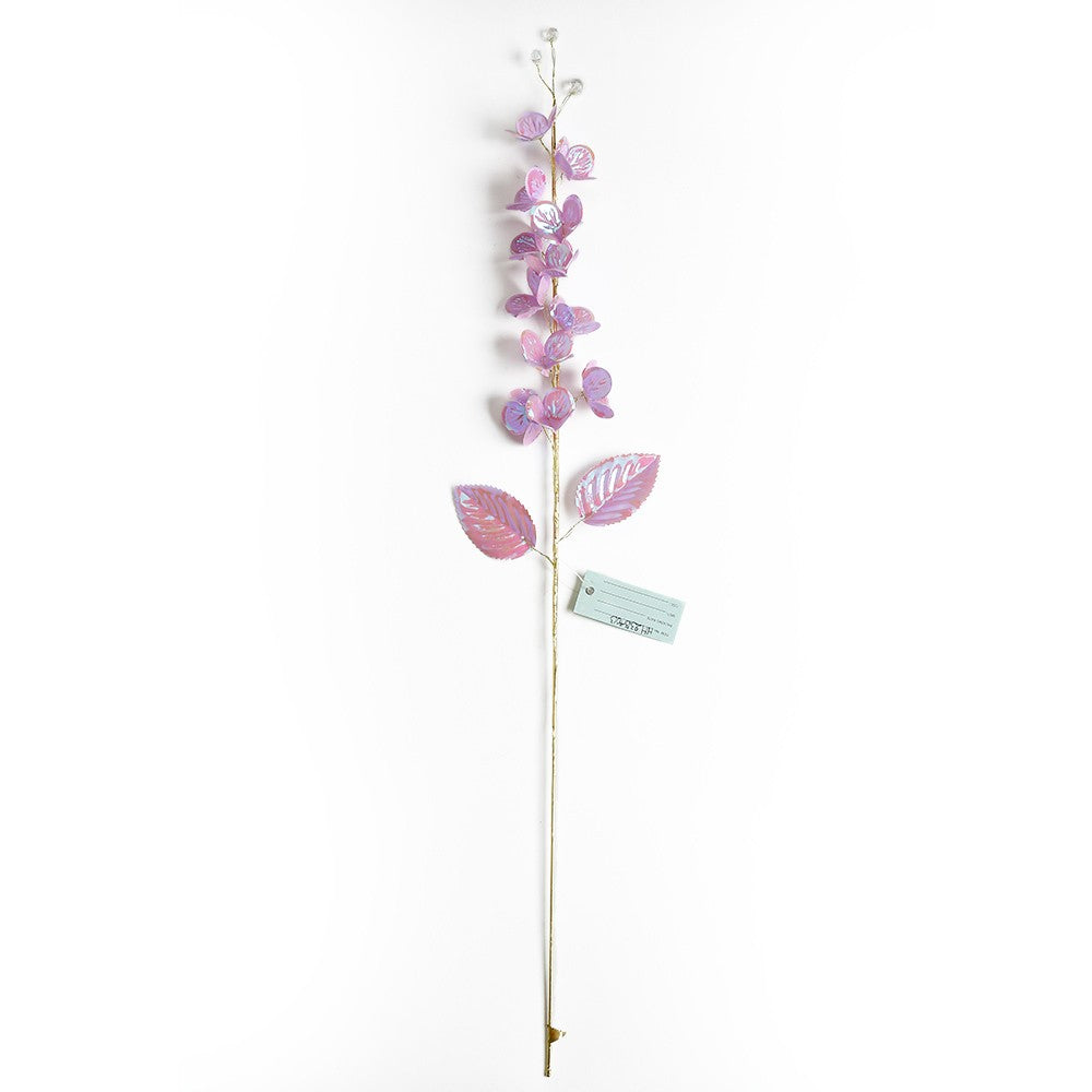 Artificial floral stem in red roses with green leaves on a black stand.