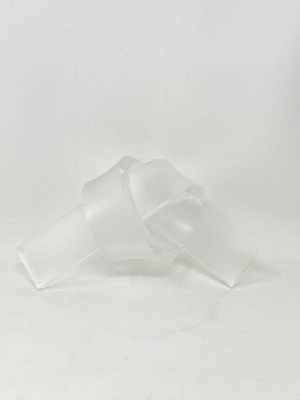 Acrylic knot pendant in clear acrylic with a silver-toned bail.