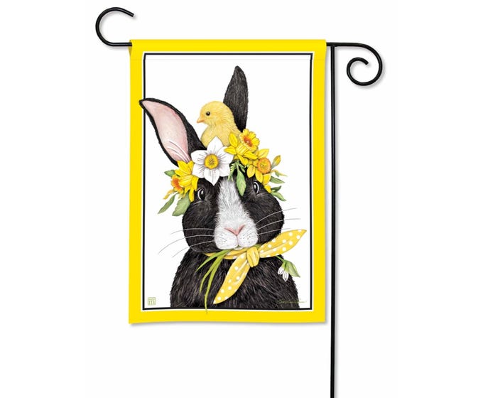 Garden flag featuring a black and white bunny wearing a floral crown and a yellow polka dot bandana.