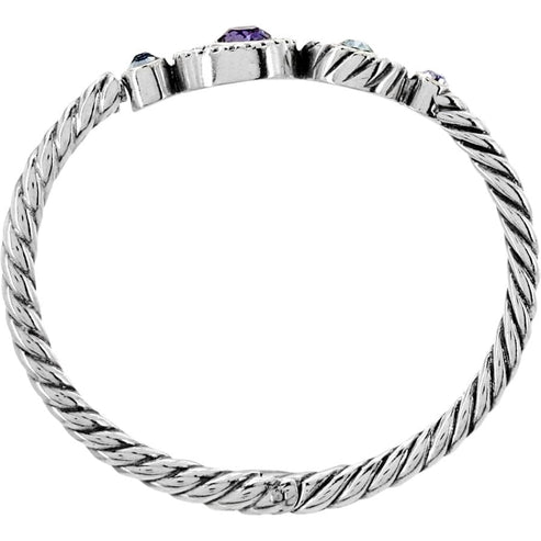 Silver-plated hinged bangle with magnetic closure featuring silver-Tanzanite crystals.