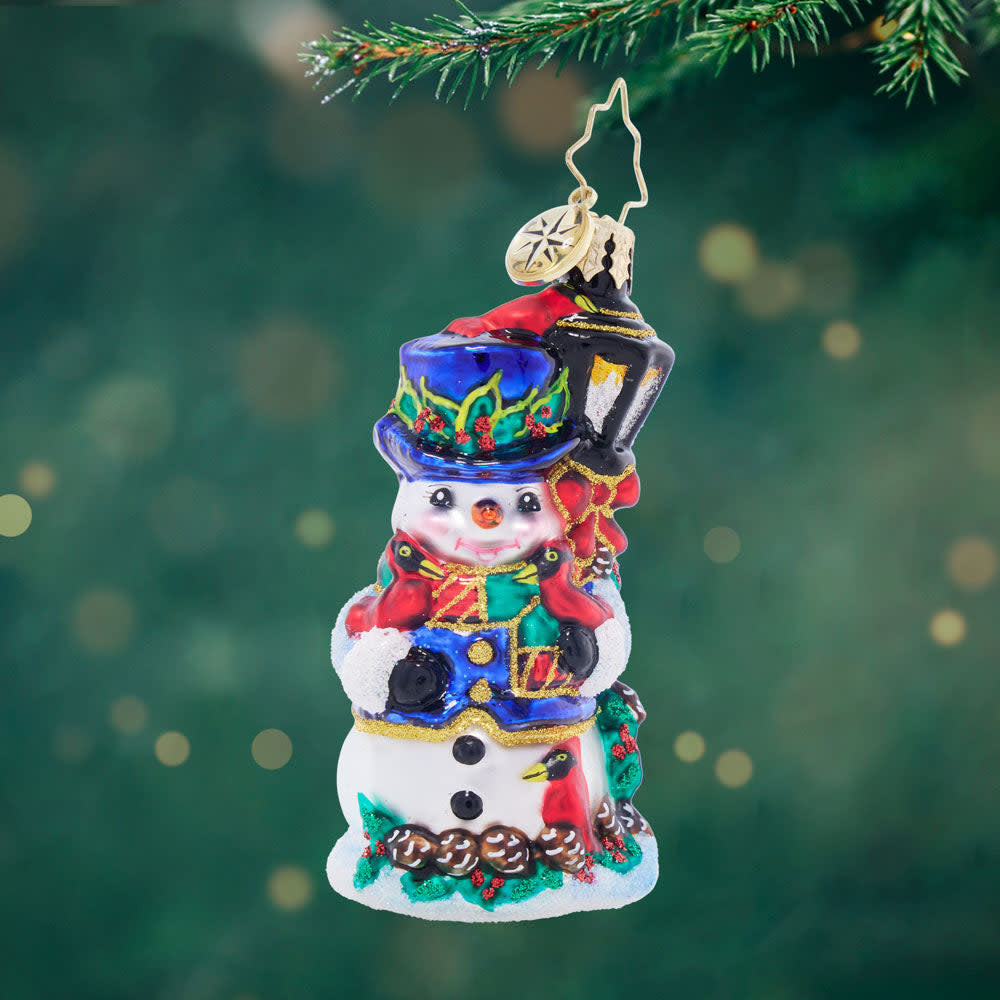 Feathered Friends Snowman Gem: a small red cardinal perched on a smiling white snowman figurine.
