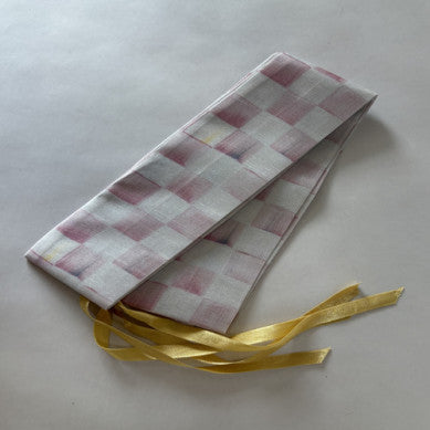 Handmade Rosy Check cord cover in pink poly silk dupioni with a half-inch pattern on metal frame.