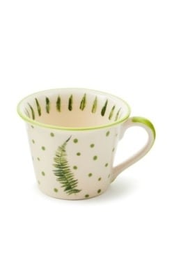 Handmade stoneware mug in fern green with a forest leaf pattern.
