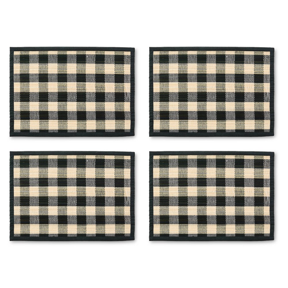 Set of four rectangular woven straw placemats with a black and tan checkered pattern.