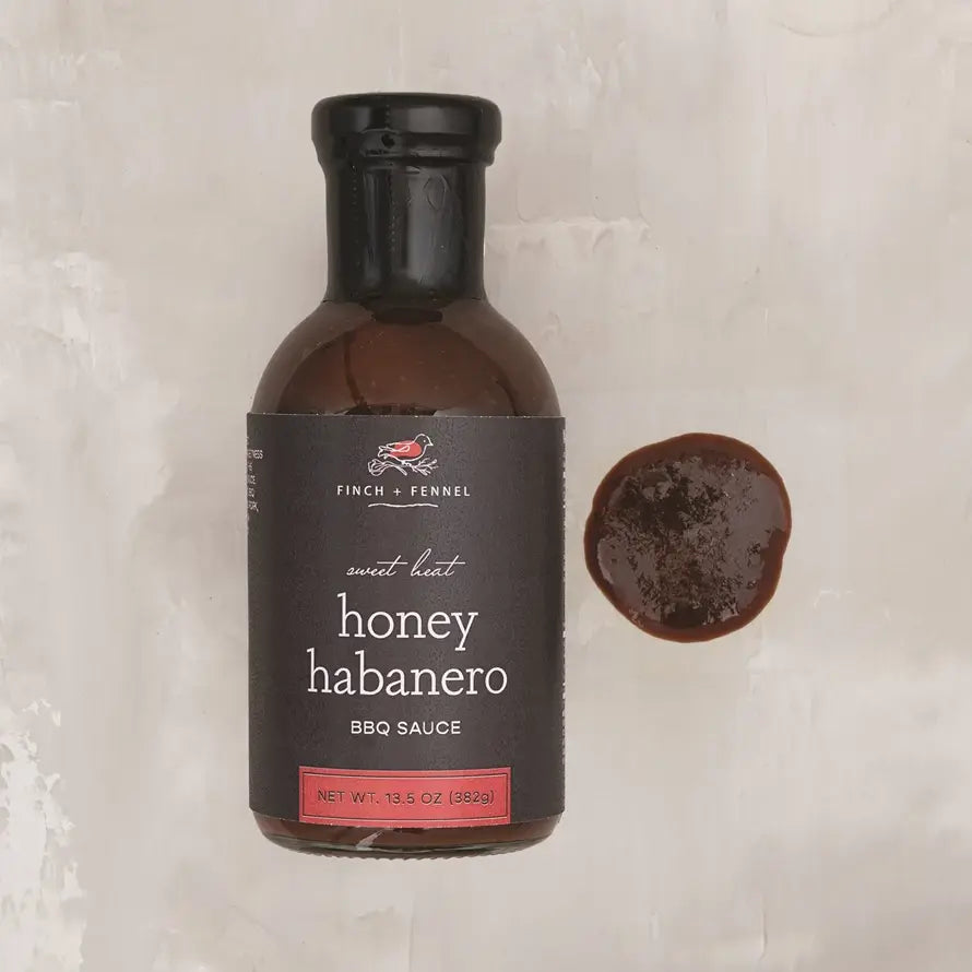 Bottle of Sweet Heat Honey Habanero BBQ Sauce with a red label.