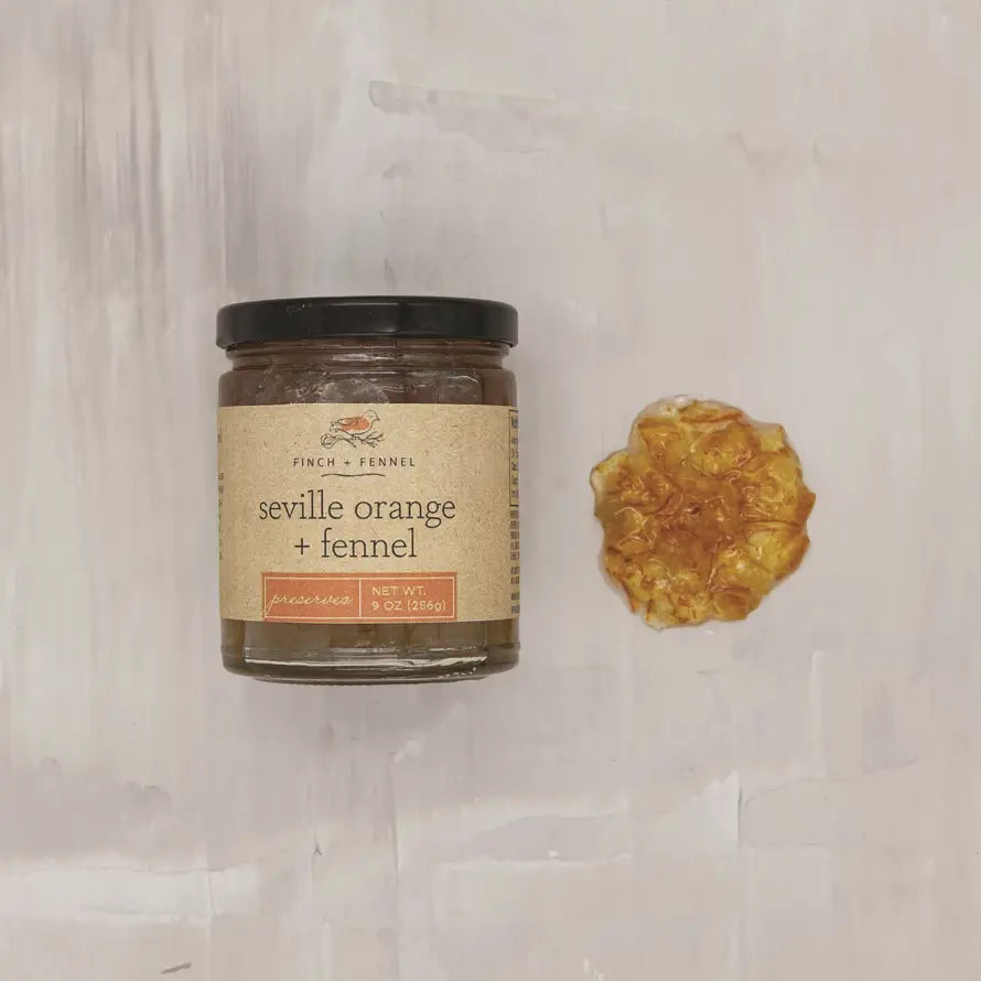 Jar of Seville Orange and Fennel marmalade spread with citrusy preserves.